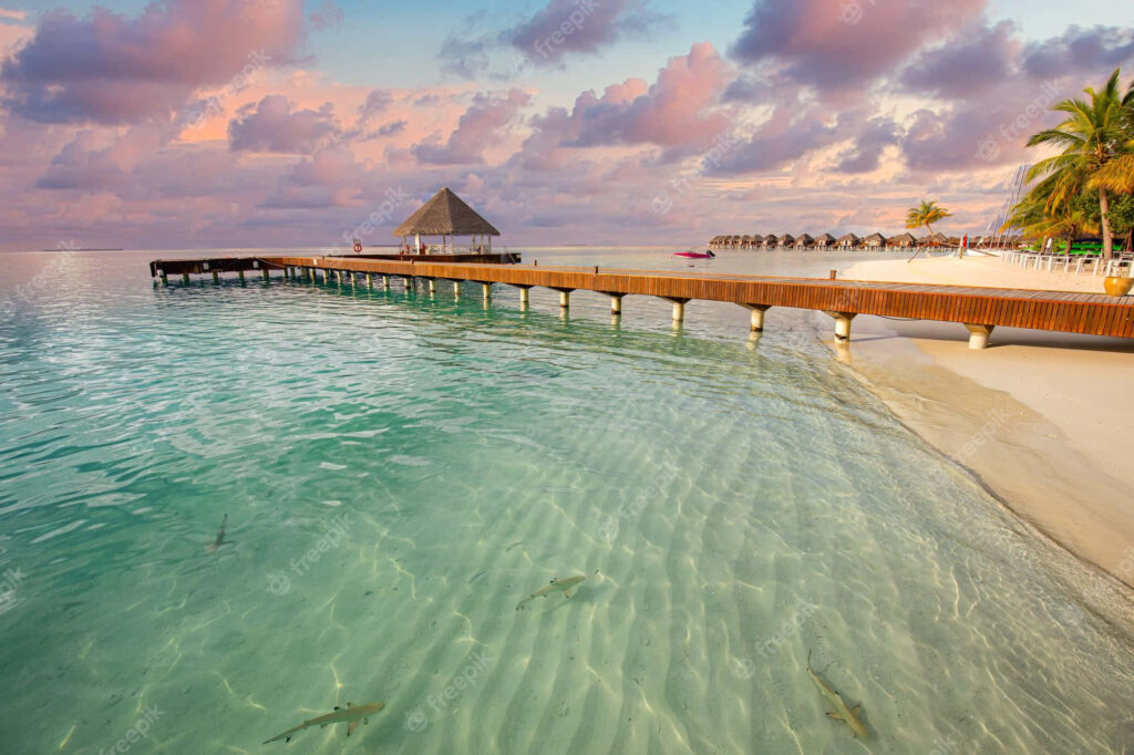 Idyllic Sunset Wallpaper: Wooden Walkway Over Turquoise Waters