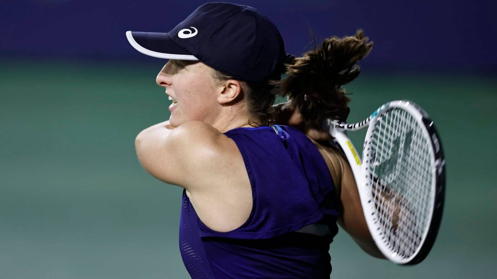 Tennis champion Iga Świątek backhand action in navy gear vibrant court dynamic wallpaper