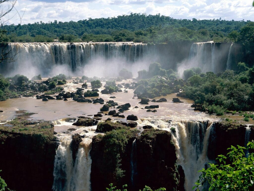 Iguassu Falls Brazil waterfall cascading over rocks lush green trees tropical landscape wallpaper