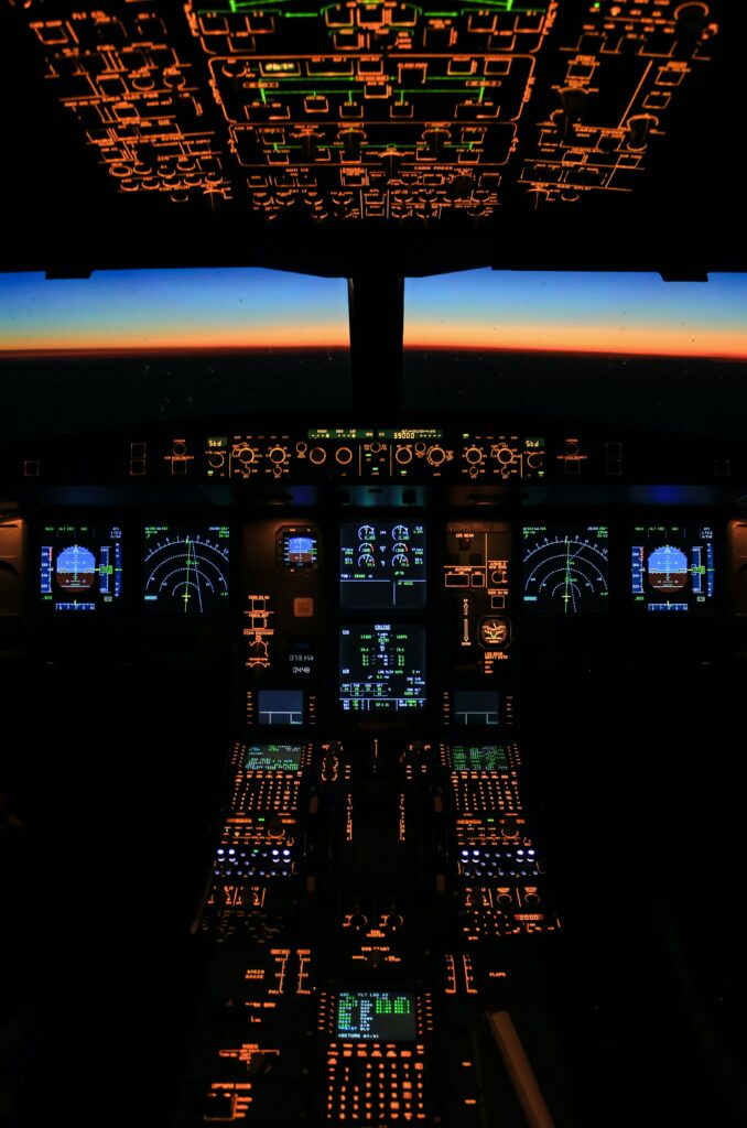 Illuminated Airplane Cockpit Wallpaper: Evening Flight Display