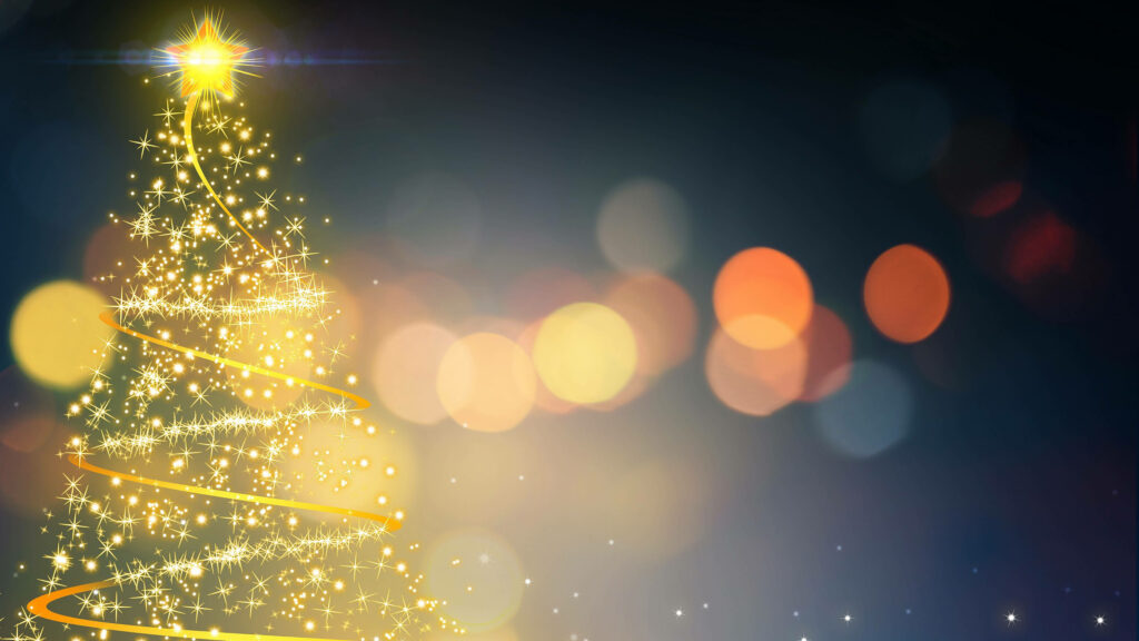 Illuminated Christmas Tree Wallpaper with Warm Bokeh Background