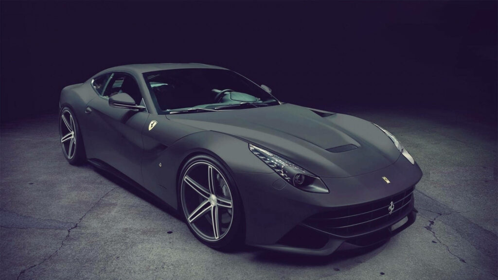 Power and Elegance: Captivating Shot of a Sultry Black Ferrari F12 Surrounded by Subtle Shadows Wallpaper