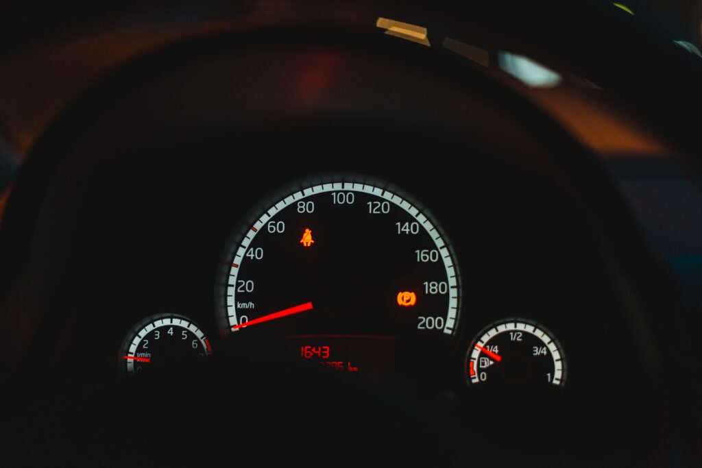 Illuminated Speedometer Wallpaper: Close-Up Dashboard Design View