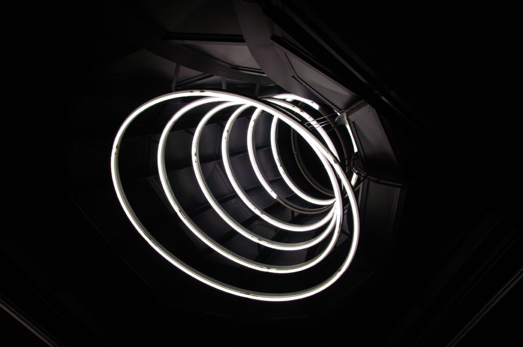 Stunning Spirals: Illuminated White Rings on Dark Background Wallpaper