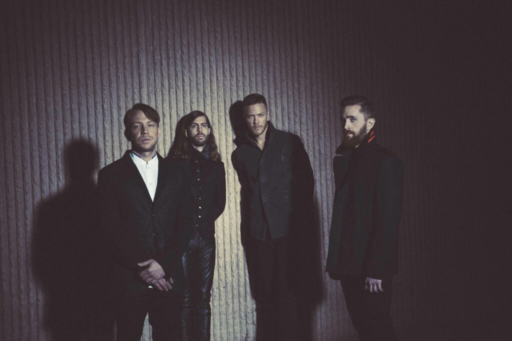 Imagine Dragons 2015 album photoshoot band members posing with dramatic lighting and textured wall Wallpaper
