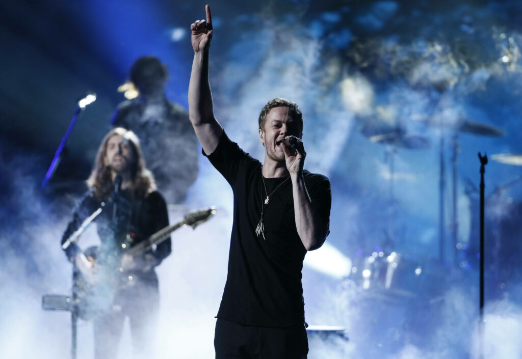Imagine Dragons live concert smoky stage dramatic lighting energetic performance wallpaper background