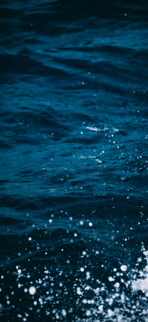 Dive into the mesmerizing depths: Iphone Xs Ocean background photo captures the rich blues, lively ripples, and playful splashes. Wallpaper