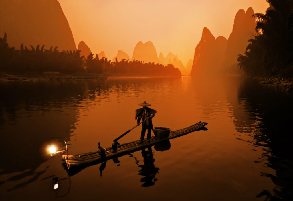 Voyage through Autumn Splendor: Serene Journey in a Handcrafted Boat amidst a Picturesque Lake and Majestic Mountains - 5K Wallpaper Masterpiece