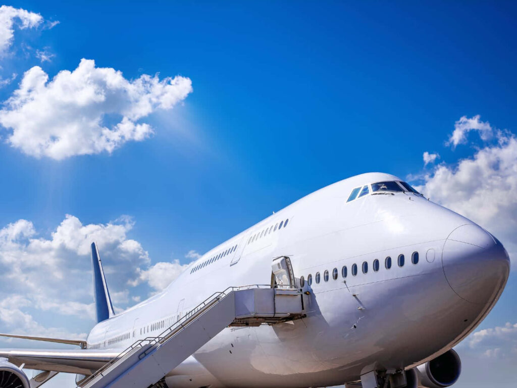 Sky's the Limit: Captivating 1440p Jumbo Jets Wallpaper Immersed in Serene Blue Skies
