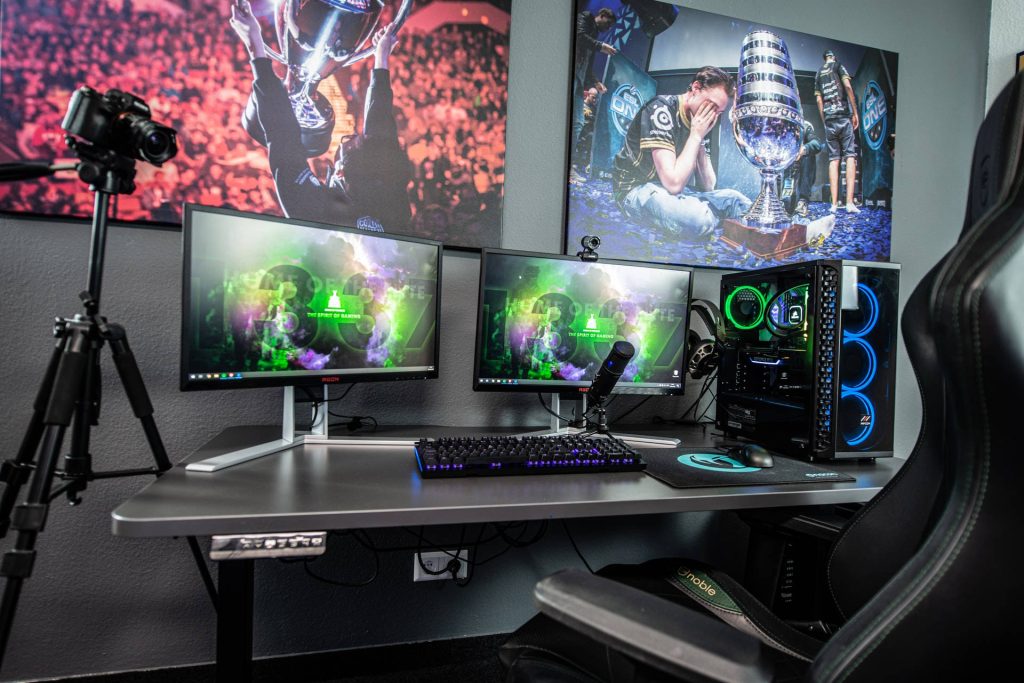 Immersive dual-monitor AOC streamer setup with RGB gaming PC and ESL One esports posters Wallpaper