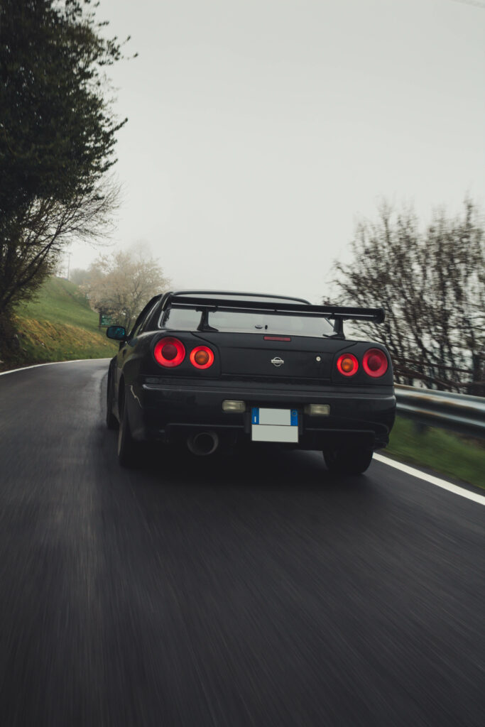 The Majestic Nissan Skyline Gtr R34 Coupe: A Timeless Masterpiece on the Open Road Wallpaper