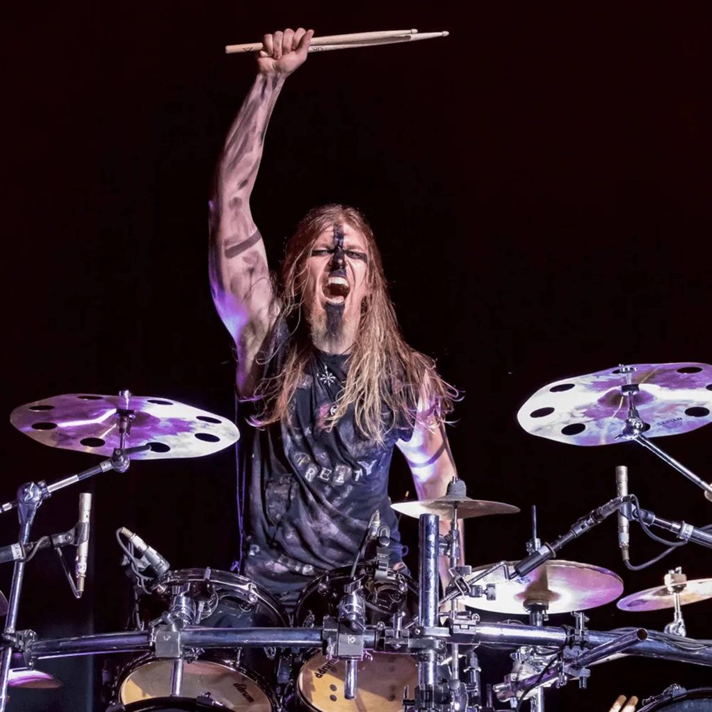 In This Moment drummer Kent Diimmel performing live with dramatic face paint on dark stage Wallpaper