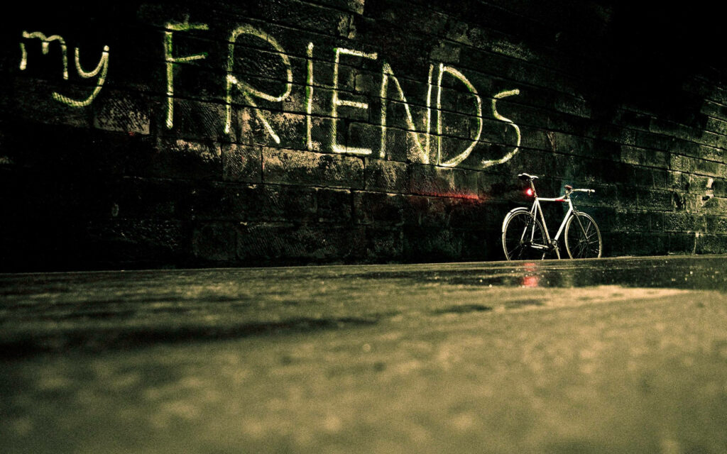 Puddle-laden Dark Alley Framed by Graffiti Art: A Charming Bicycle Rests against a Weathered Wall in the Presence of Friendship Wallpaper