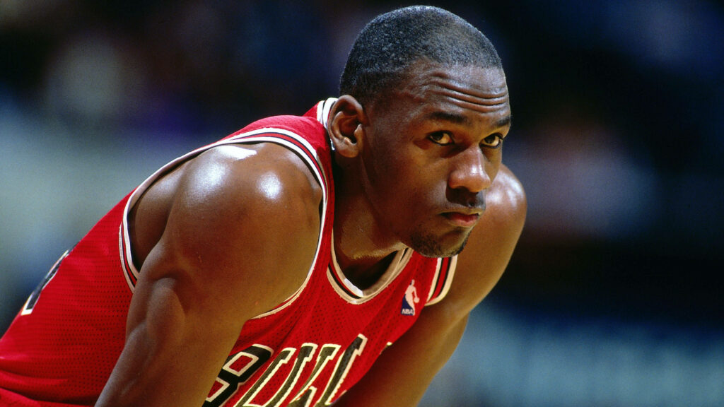 The Relentless Roar: Michael Jordan's Unleashed Passion for Victory Echoes on the Court. Wallpaper