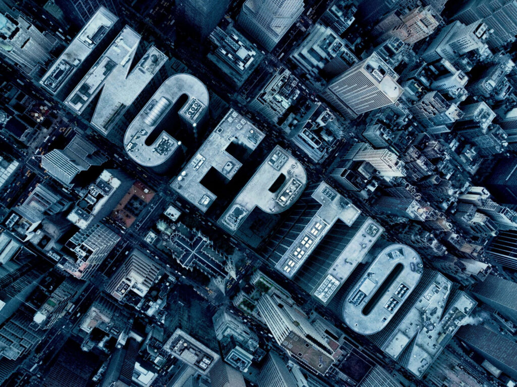 Inception movie wallpaper cityscape aerial view with integrated title showcasing reality illusion