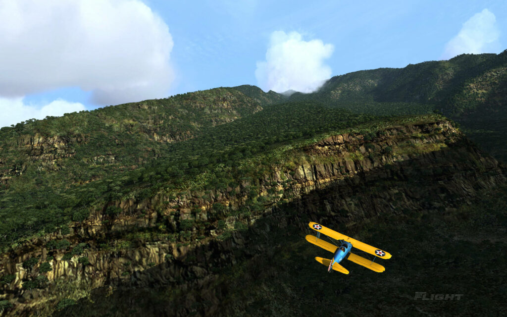 Stunning Aerial Shot: Majestic Stearman Model 75 Biplane Soaring Over Breathtaking Mountain Range in Microsoft Flight Simulator Wallpaper