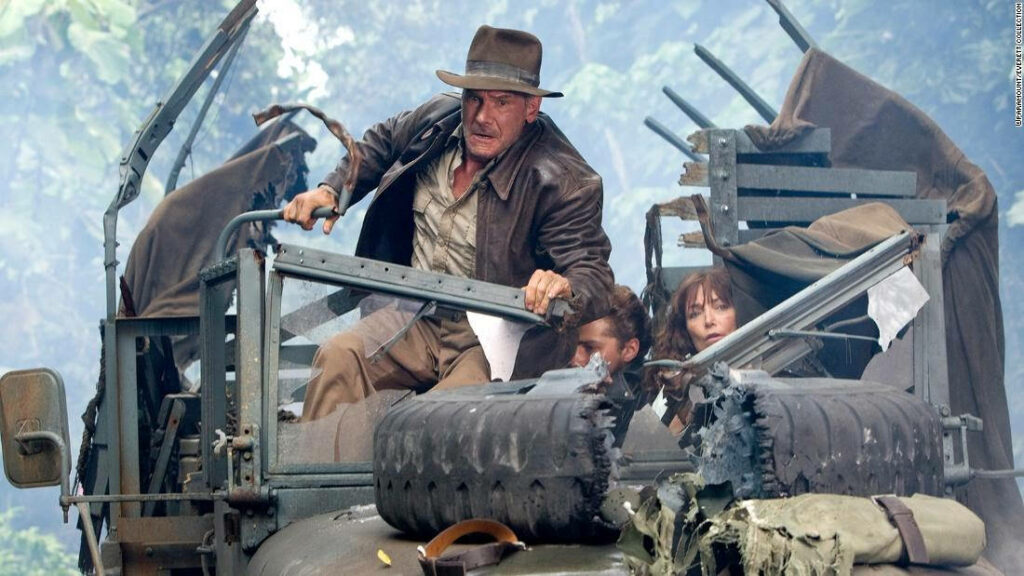 Indiana Jones Jungle Chase Wallpaper: Action-Packed Adventure Scene