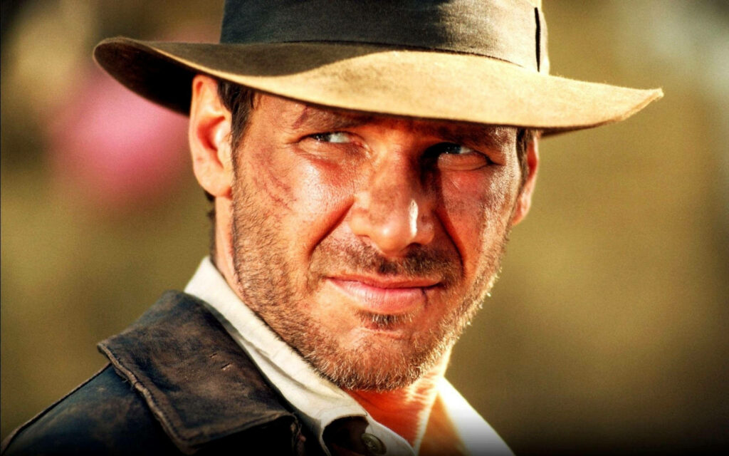 Iconic Indiana Jones Wallpaper: Harrison Ford's Rugged Adventurer Look