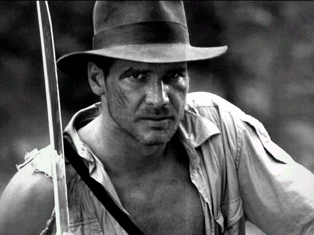 Iconic Indiana Jones Wallpaper: Harrison Ford in Rugged B&W Adventure