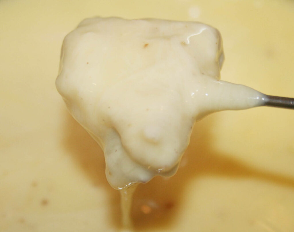 Indulgent Cheese Fondue Close-Up: Dripping Delight Wallpaper
