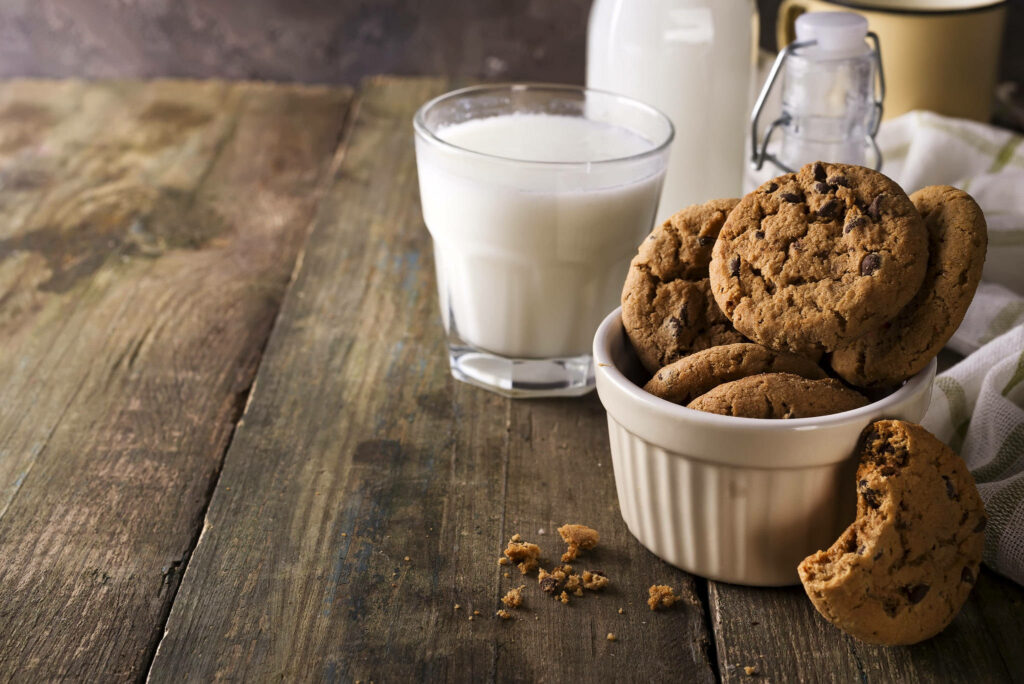 The Sweetest Duo: Tempting Chocolate Chip Cookies and Refreshing Milk Bliss Wallpaper