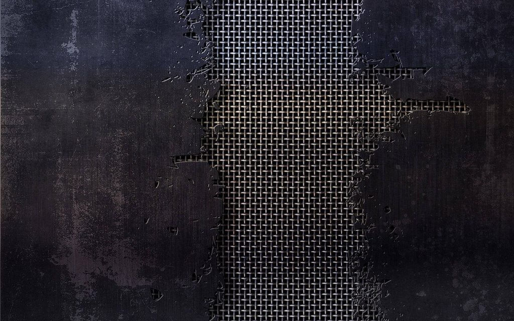 Industrial wallpaper with weathered black concrete revealing metallic wire mesh background