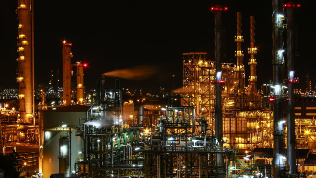 Industrial Brilliance: Captivating HD Wallpaper of a Chemical Plant Amidst the Night