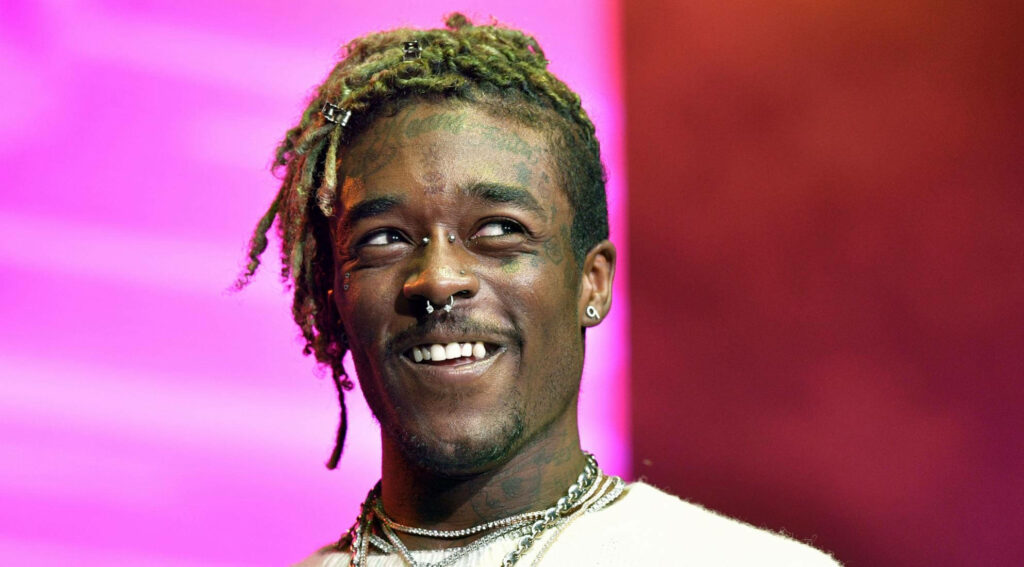 Enthralling Charisma: Lil Uzi Vert's Infectious Energy Shines Through in Stylish Attire Wallpaper