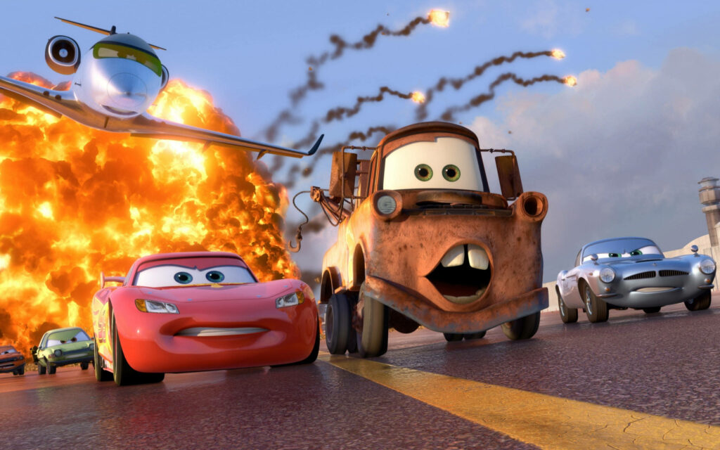 Race for Survival: Pixar's Cars Dodge Flames and Missiles on the Fiery Highway Wallpaper