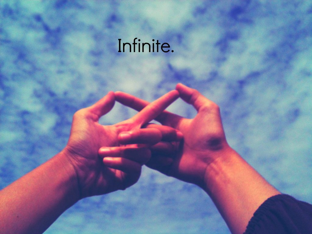 Two hands forming infinity symbol against bright blue sky celebrating eternal friendship wallpaper