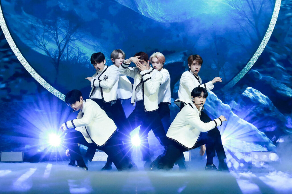 Enhypen's Dazzling Debut: A Mesmerizing Black and White Melody Amidst Enchanting LED Forest Lights Wallpaper