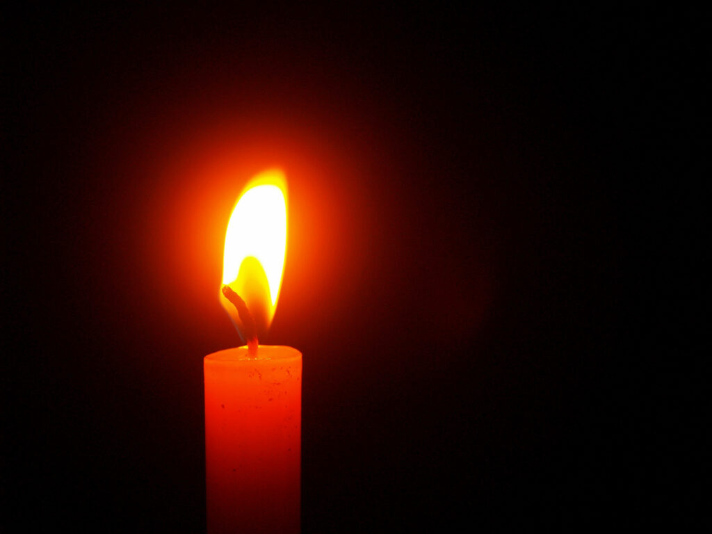 Serenity Illuminated: Enchanting Candlelight Embraces the Black Screen Wallpaper