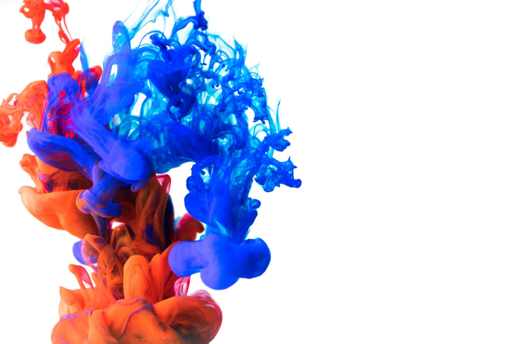 Dynamic Clash: Exploding Red and Blue Ink Unleash Abstract Energy Wallpaper