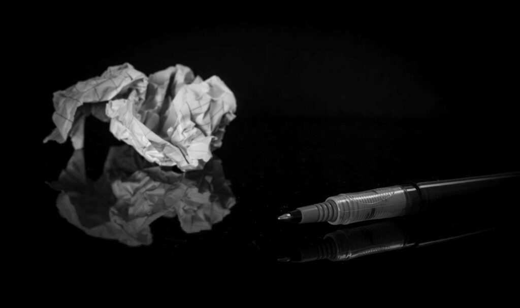 Inky Shadows: A Captivating Background Snapshot of Crumpled Paper and Pen Wallpaper