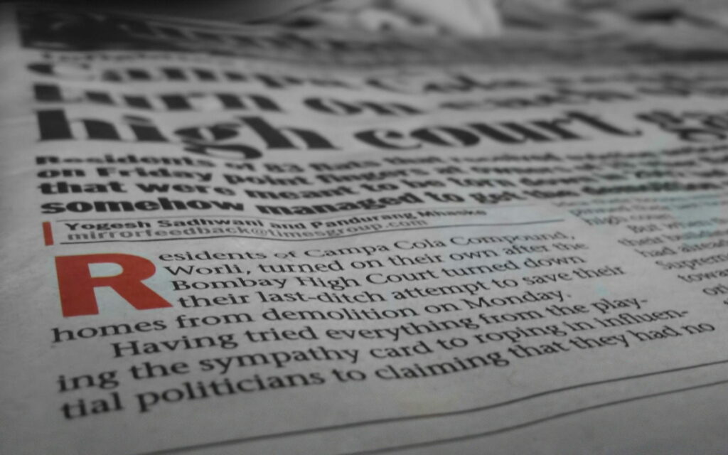 Ink-Stained Stories: A High-Definition Wallpaper of the Dedicated Journalist Amid Newspapers