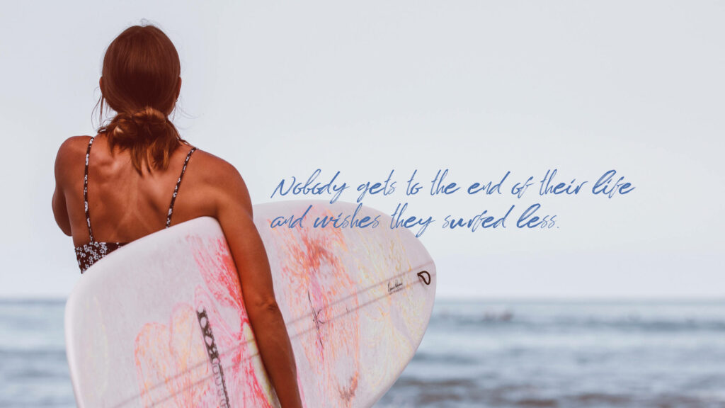 Inspirational Surfing Adventure: A Woman Gazes at the Ocean Waves Wallpaper