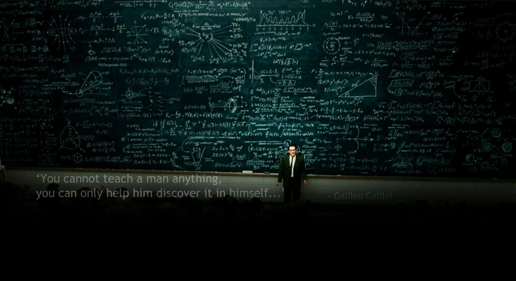 Physics teacher explains complex equations on chalkboard with Galileo quote in dark academic setting Wallpaper