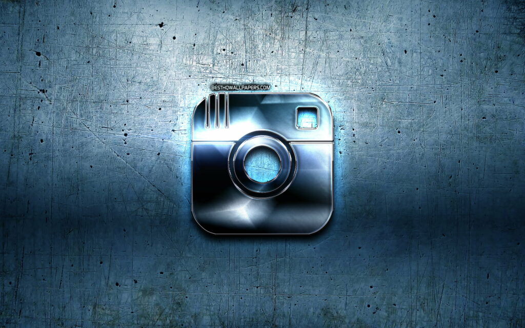 3D chrome Instagram logo with blue textured metal background and dramatic backlighting wallpaper