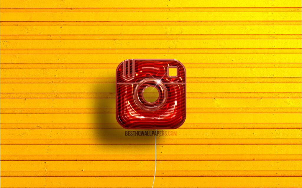 Glossy 3D red Instagram balloon logo on vibrant yellow wooden background digital wallpaper