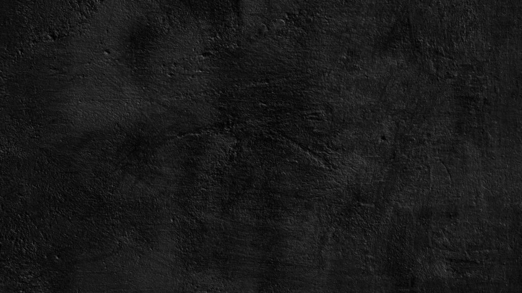 Intense black grunge textured 4K wallpaper with matte industrial surface and deep shadows background