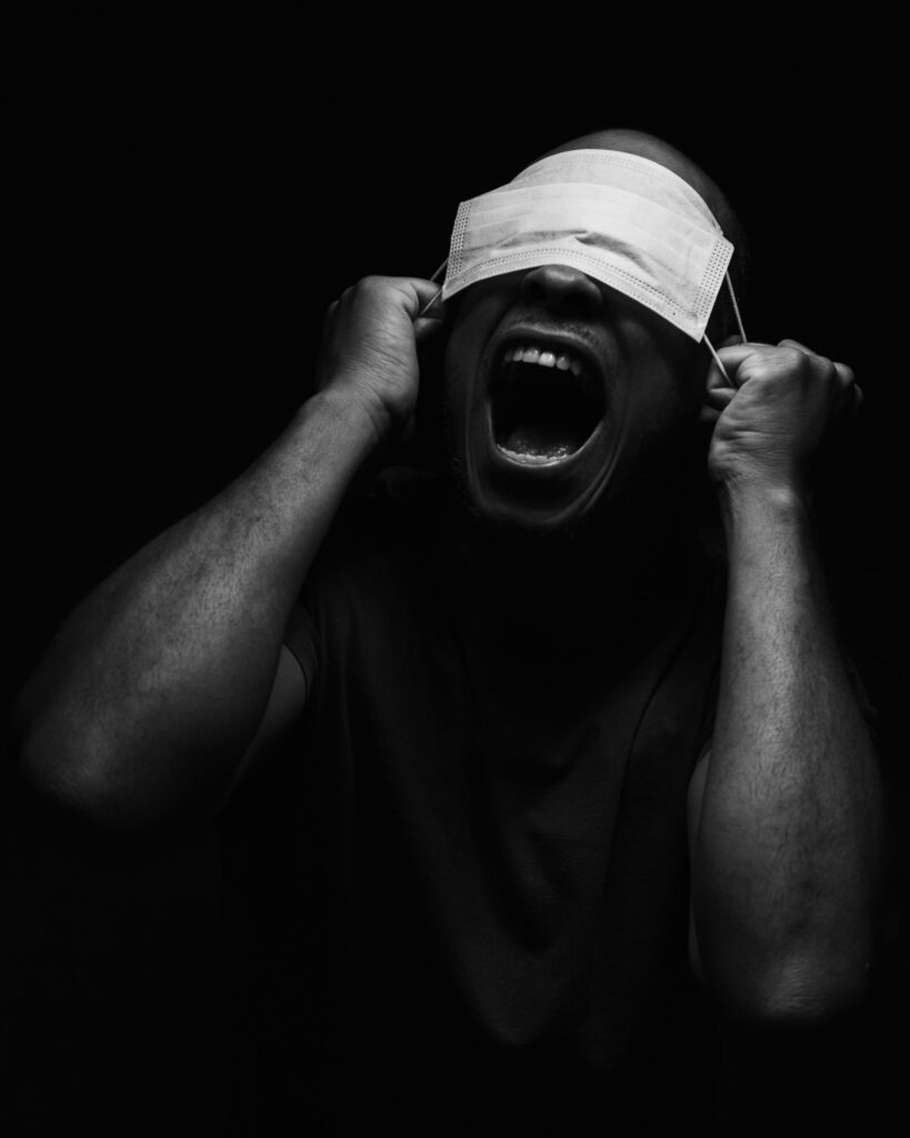 Intense Black and White Masked Portrait Wallpaper with Dramatic Shadows
