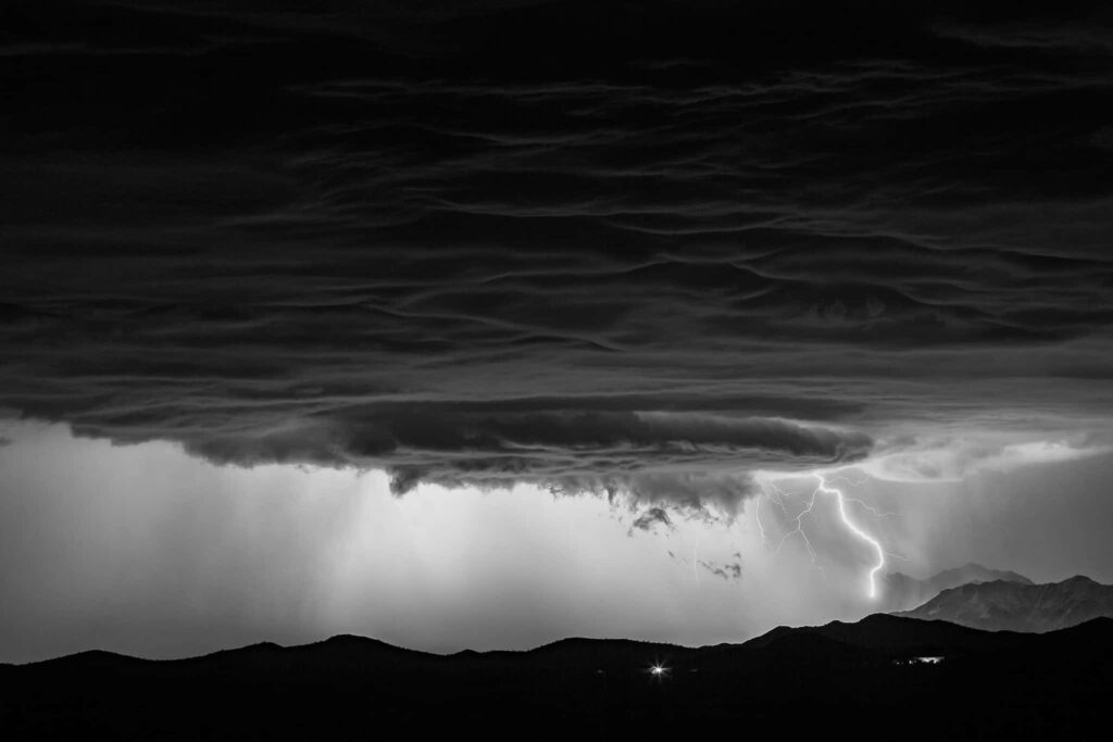 Stormy Black and White Wallpaper: Lightning Over Mountain Landscape