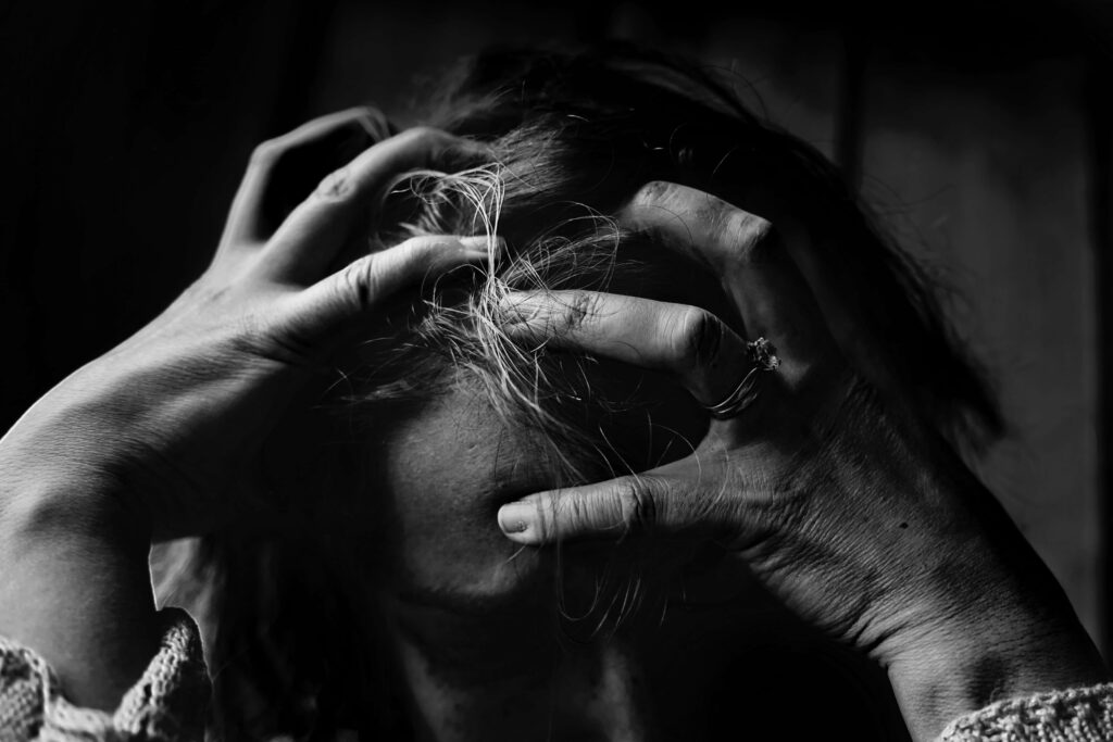 Intense B&W Portrait: Woman in Stress with Dramatic Lighting Wallpaper
