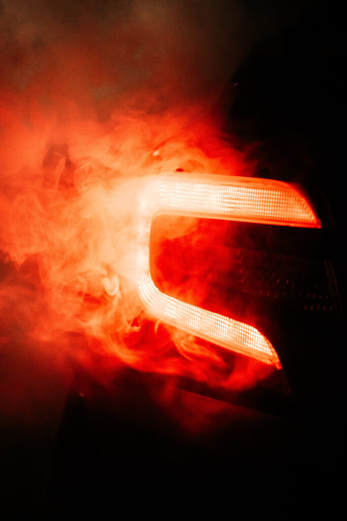 Red Taillight in Smoke: Dramatic Car Wallpaper Background