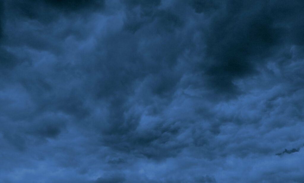 Moody Dark Blue Sky Wallpaper: Intense Cloudy Background