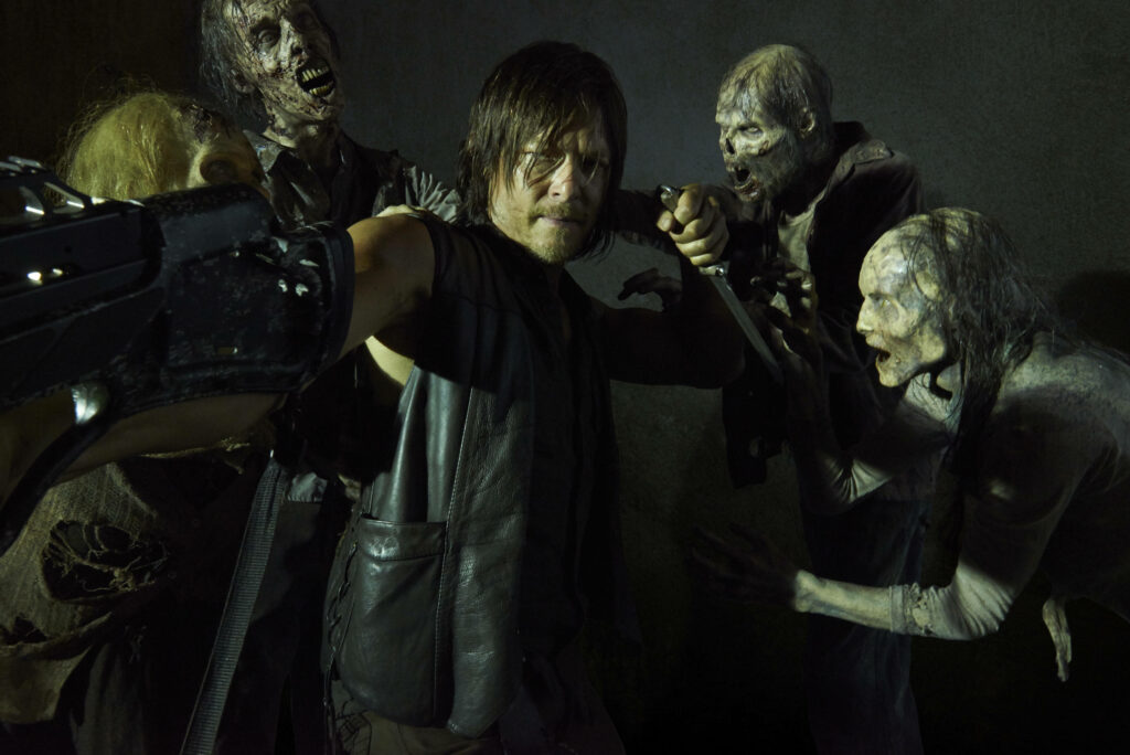 Intense Daryl Dixon Wallpaper: Survival Skills Amid Zombie Attack