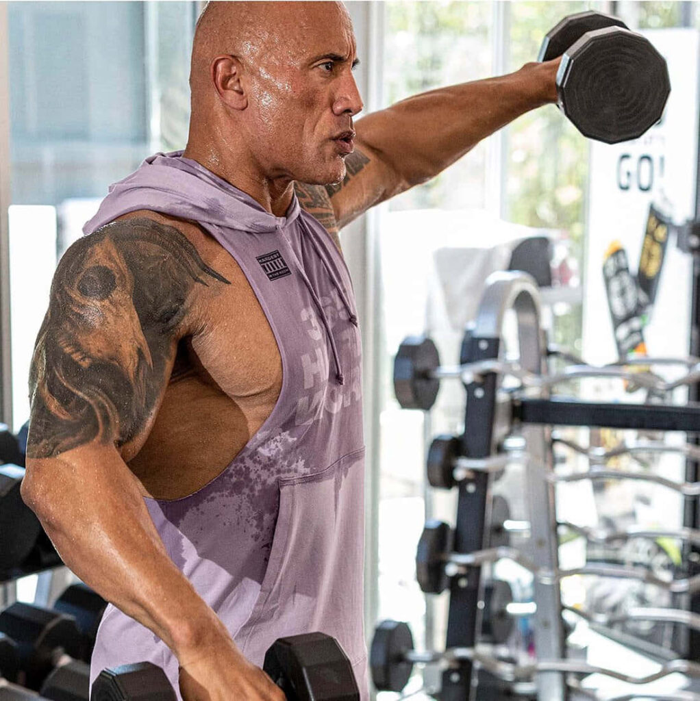 Intense Gym Workout: Dwayne Johnson in Purple Project Rock Sando Wallpaper
