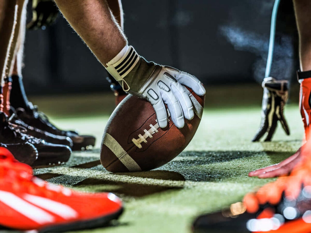 Football Intensity: Close-Up of Players Prepping for Game - Wallpaper