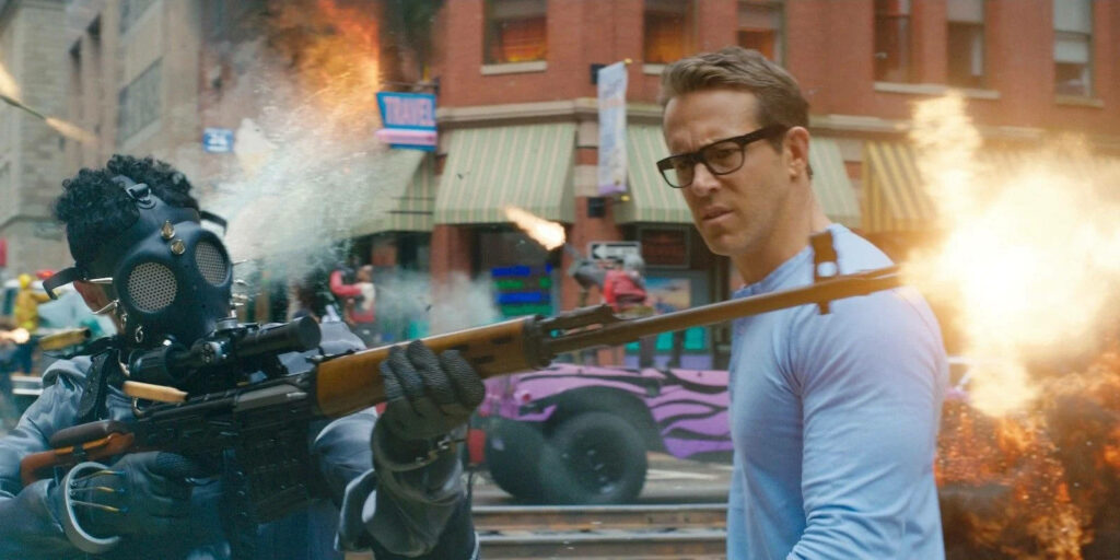 Epic Free Guy Wallpaper: Gunfire & Explosions in Urban Chaos