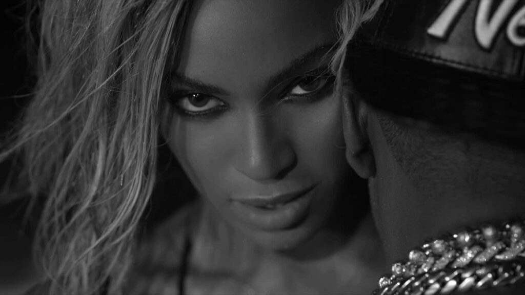 Grayscale Wallpaper: Intense Woman & Stylish Man in Dramatic Lighting